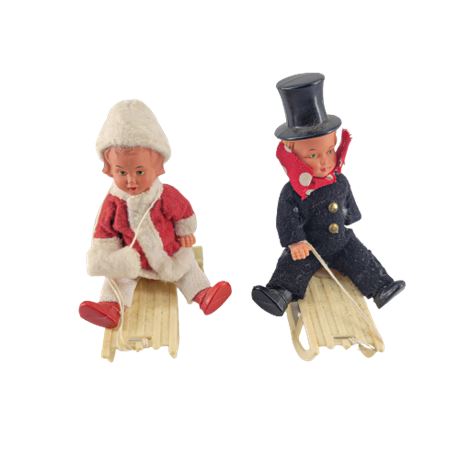 Vintage Wind-Up Boy & Girl Dolls Riding Sleds